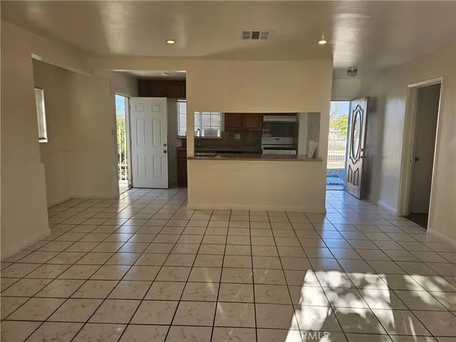 a view of a refrigerator in kitchen and a living room