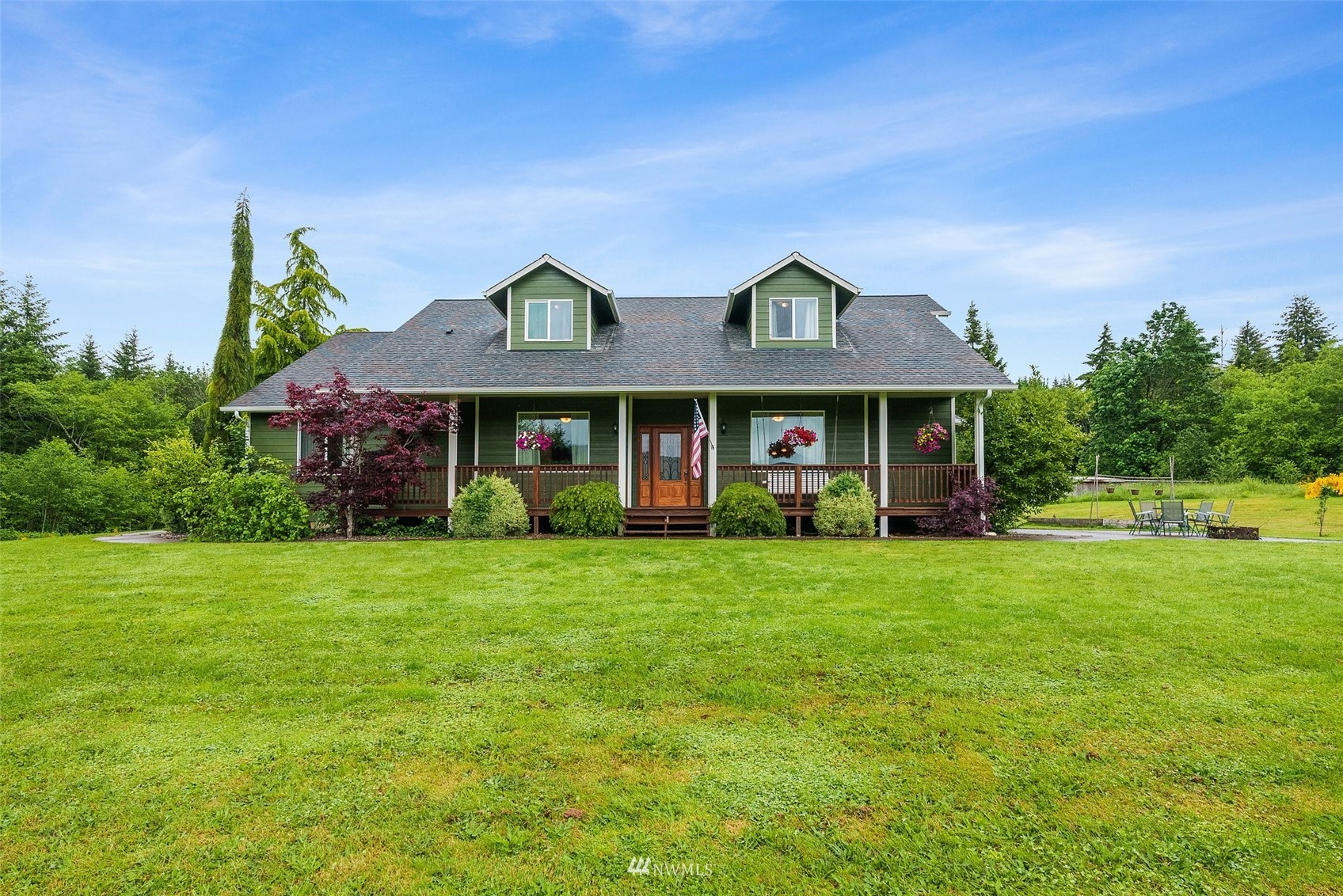 356 Wells Road Pe Ell, WA 98572 - Photo 1 of 40 a front view of a house with a garden