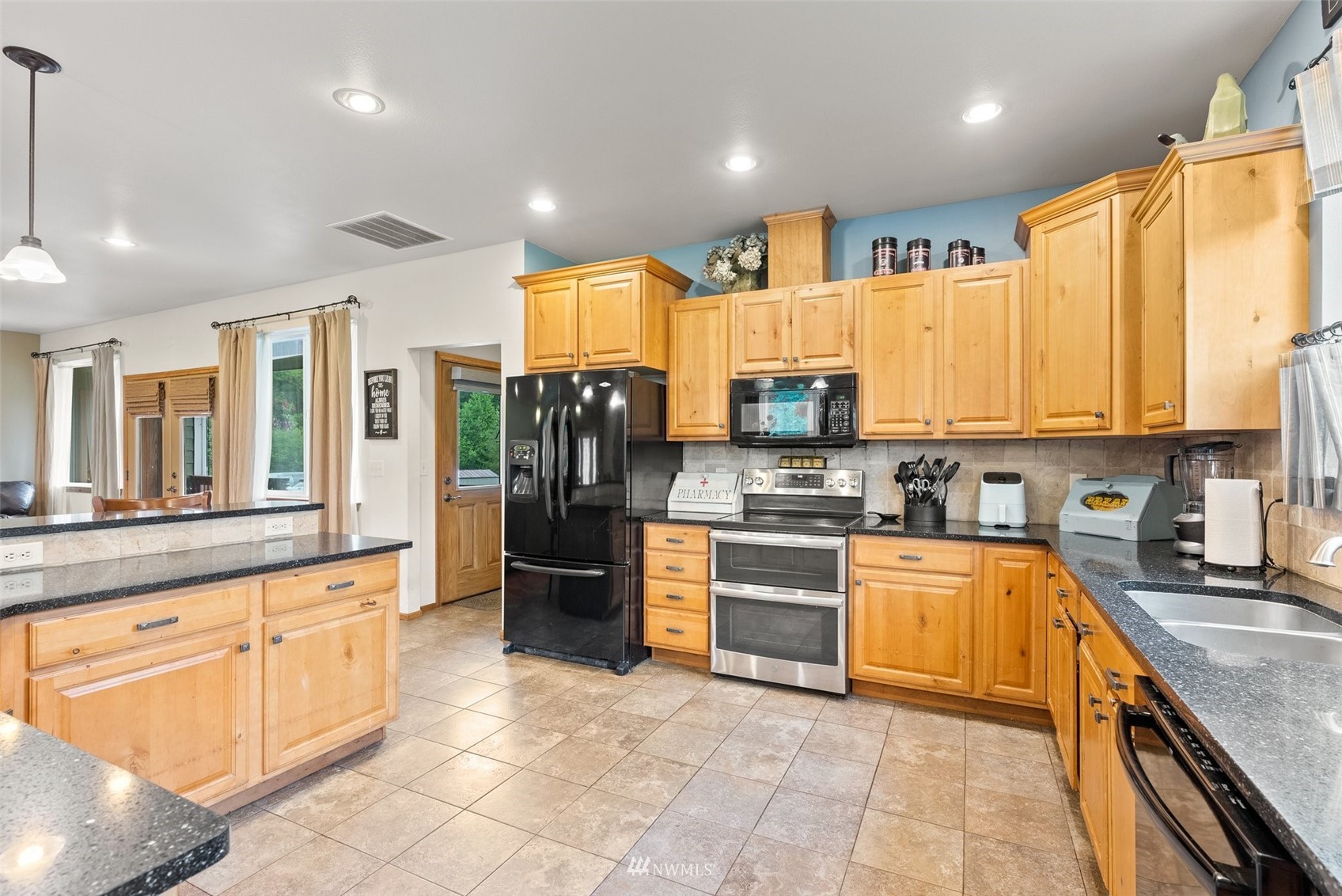 356 Wells Road Pe Ell, WA 98572 - Photo 15 of 40 a kitchen with stainless steel appliances granite countertop a stove top oven a refrigerator a sink and dishwasher