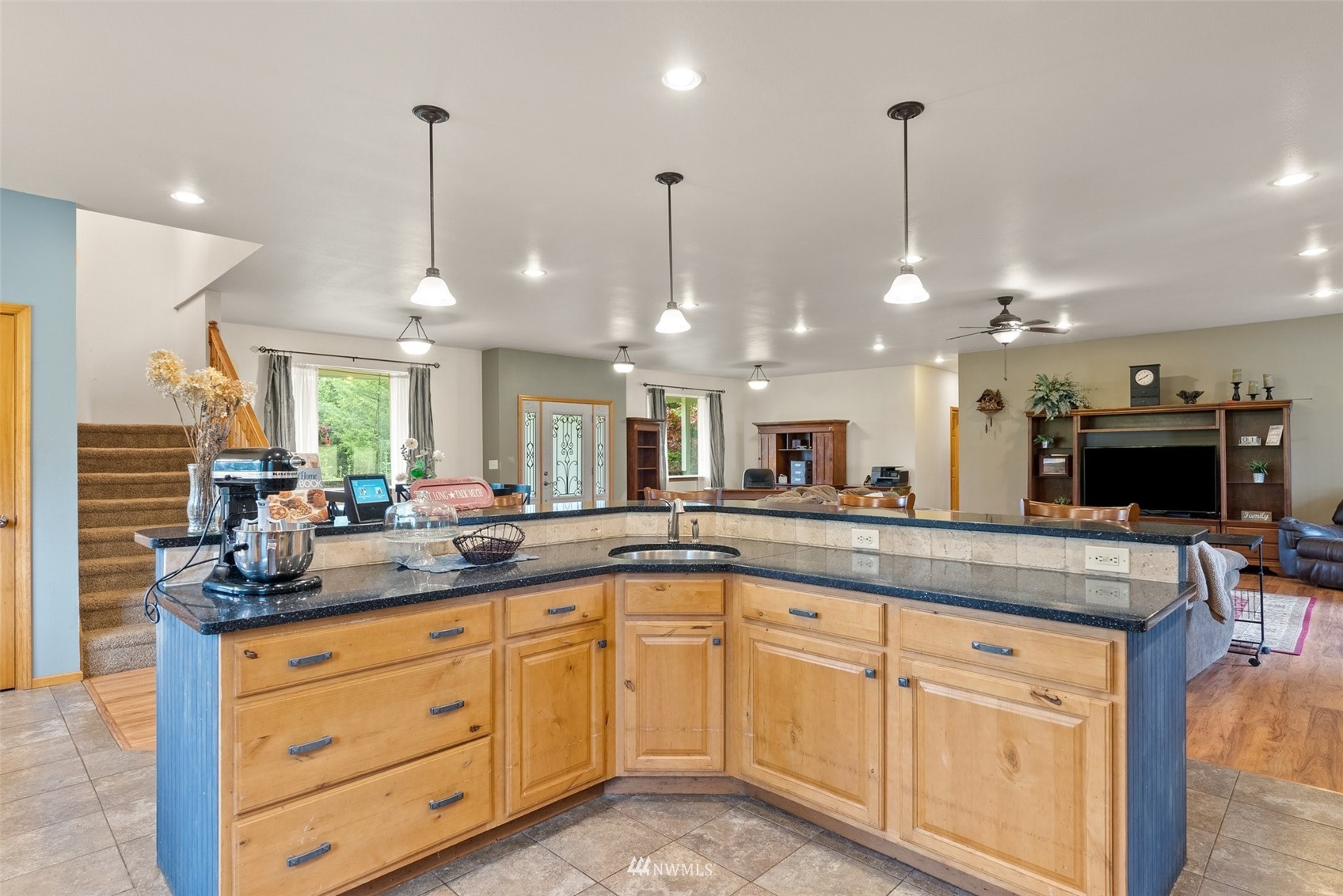 356 Wells Road Pe Ell, WA 98572 - Photo 16 of 40 a kitchen with kitchen island granite countertop a stove a sink and a wooden floors