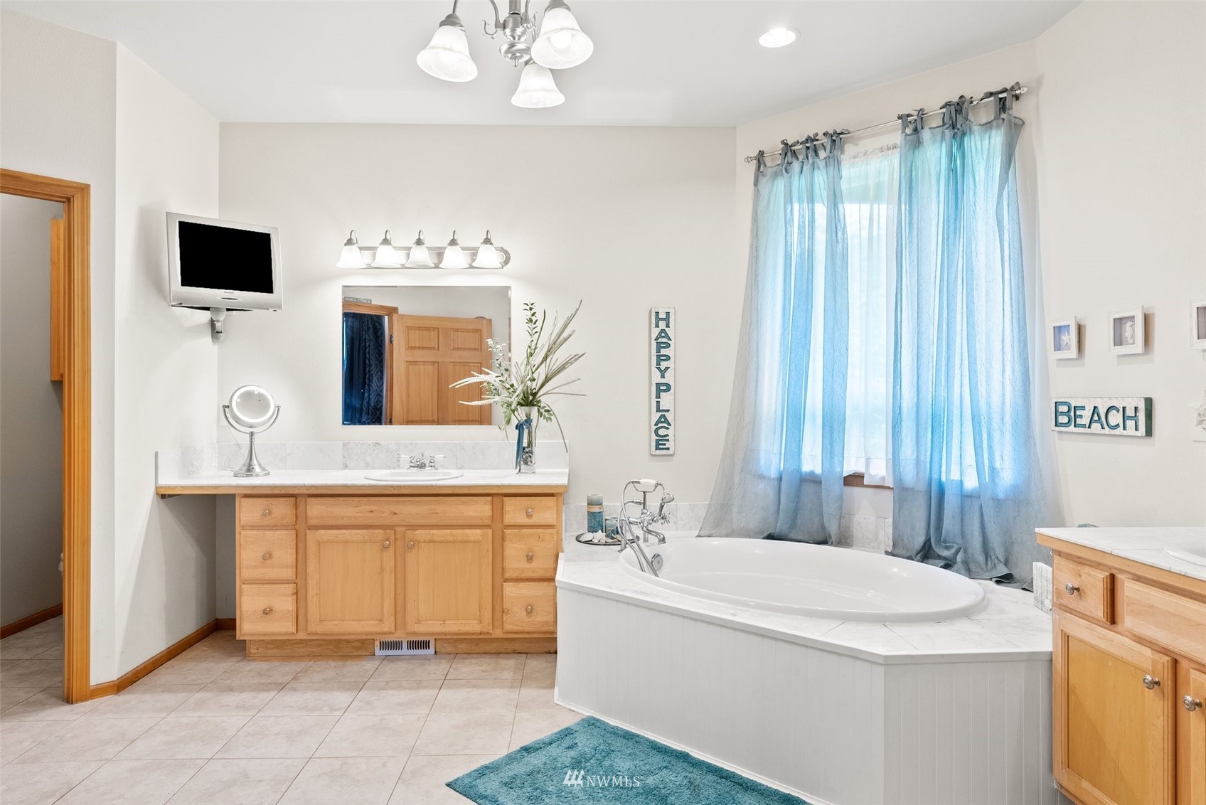 356 Wells Road Pe Ell, WA 98572 - Photo 24 of 40 a spacious bathroom with a tub sink and mirror