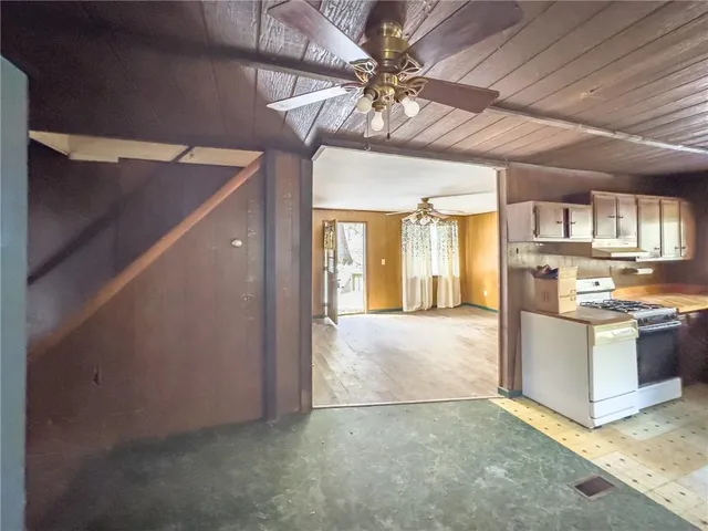 a view of a kitchen with a sink and a refrigerator