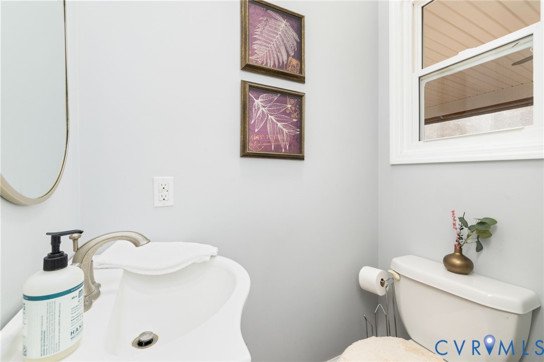 1895 Cemetery Road Chase City, VA 23924 - Photo 33 of 83 a bathroom with a toilet a sink and mirror