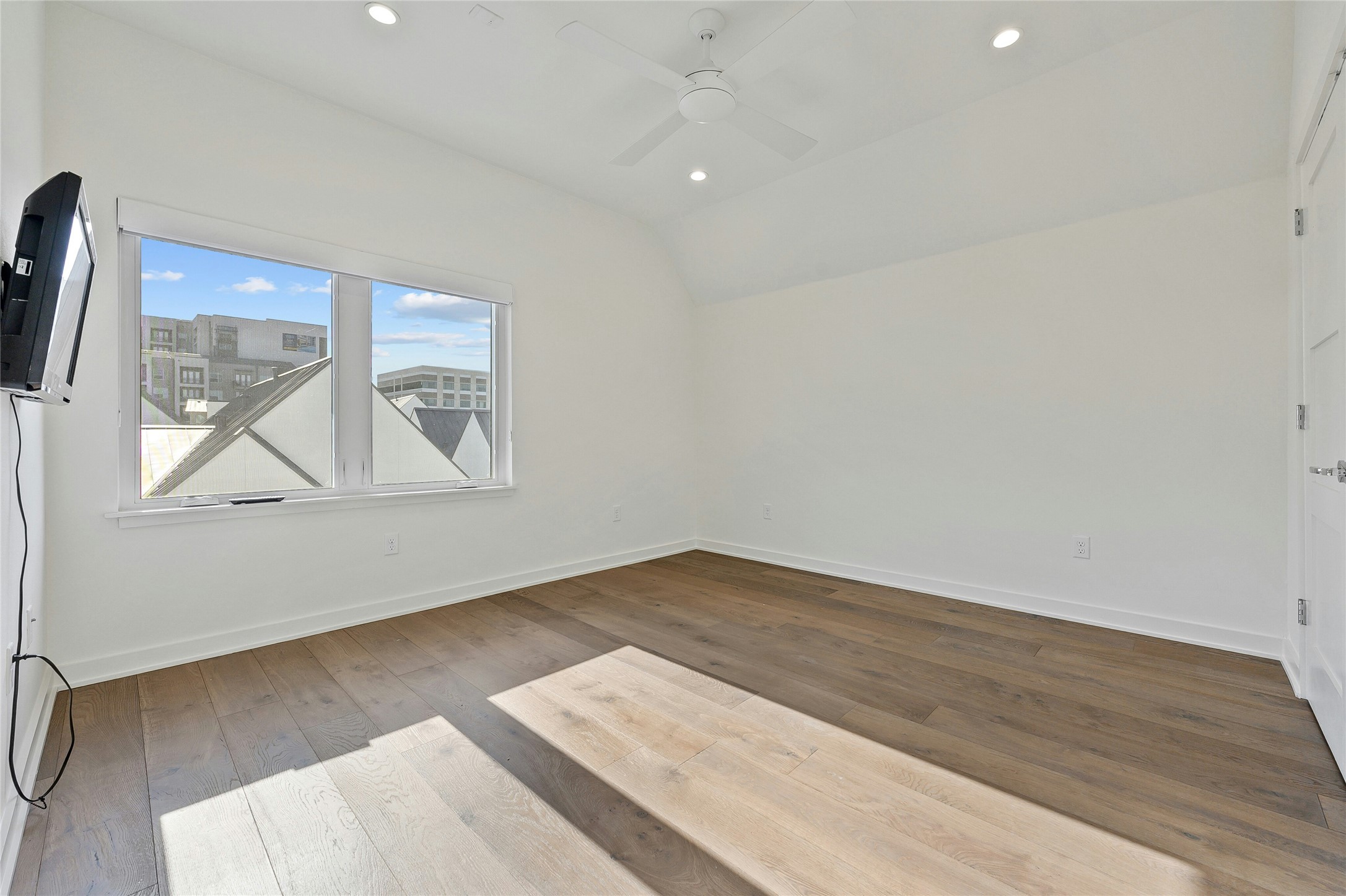 2518 Sutherland Street Austin, TX 78746 - Photo 23 of 30 Natural light cascades through broad windows onto polished hardwood flooring in this airy space.