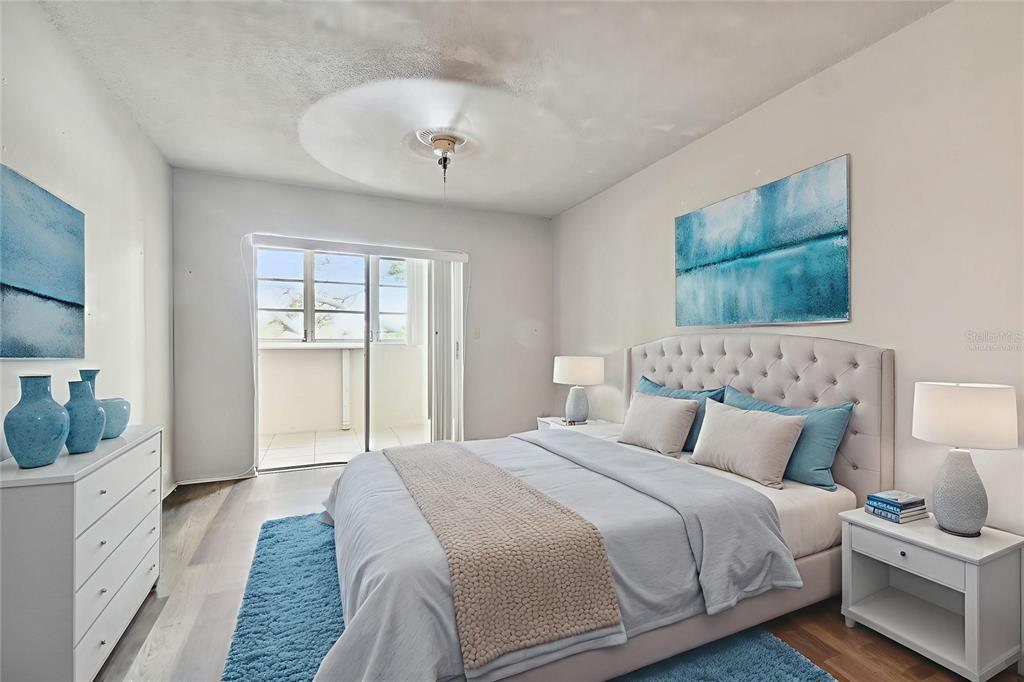 645 North Keene Road, Unit D Clearwater, FL 33755 - Photo 12 of 27 a bedroom with a large bed and a chandelier