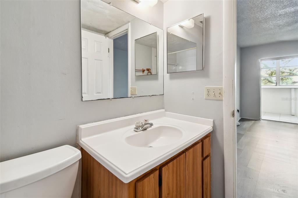 645 North Keene Road, Unit D Clearwater, FL 33755 - Photo 13 of 27 a bathroom with a sink toilet and mirror