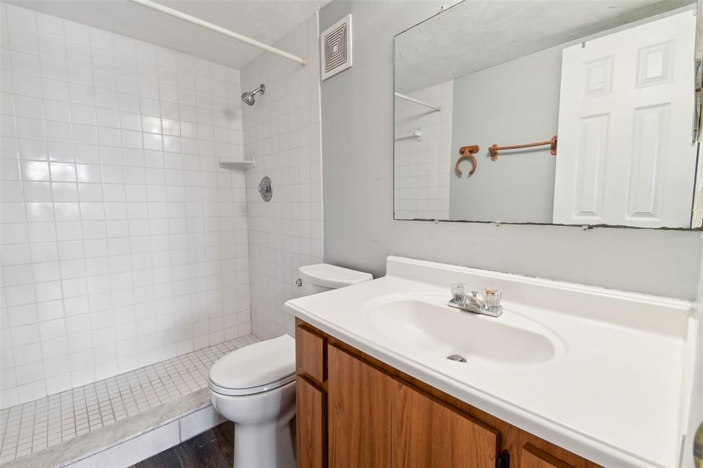 645 North Keene Road, Unit D Clearwater, FL 33755 - Photo 14 of 27 a bathroom with a sink toilet and shower