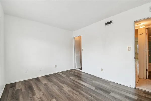 an empty room with wooden floor