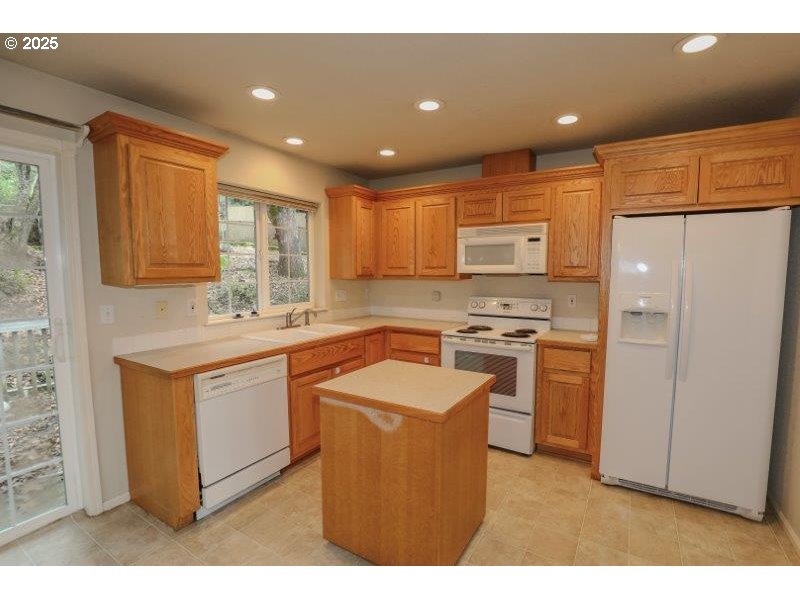 1147 Southeast Kane Street Roseburg, OR 97470 - Photo 14 of 41 a kitchen with stainless steel appliances granite countertop a sink stove and refrigerator