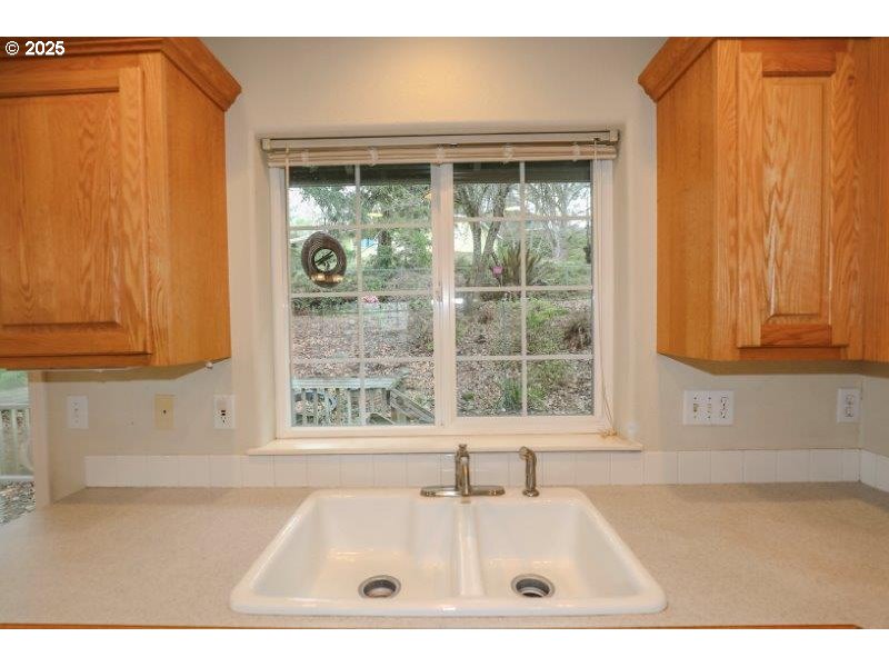 1147 Southeast Kane Street Roseburg, OR 97470 - Photo 16 of 41 a white bath tub sitting in a bathroom next to a window