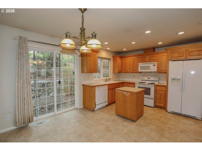 1147 Southeast Kane Street Roseburg, OR 97470 - Photo 18 of 41 a kitchen with a refrigerator and a sink