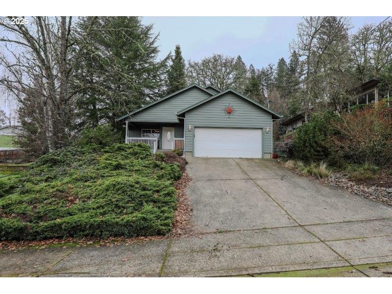 1147 Southeast Kane Street Roseburg, OR 97470 - Photo 3 of 41 a view of a house with a yard and large tree