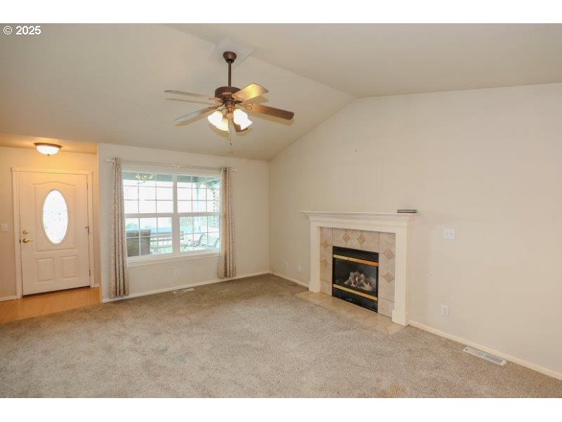 1147 Southeast Kane Street Roseburg, OR 97470 - Photo 6 of 41 a view of an empty room with a fireplace and a window