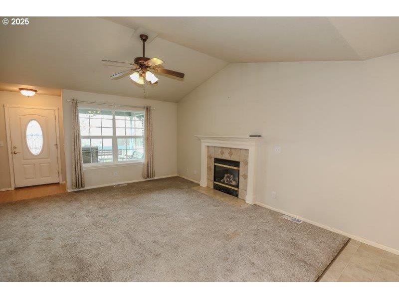 1147 Southeast Kane Street Roseburg, OR 97470 - Photo 10 of 41 an empty room with windows and fireplace