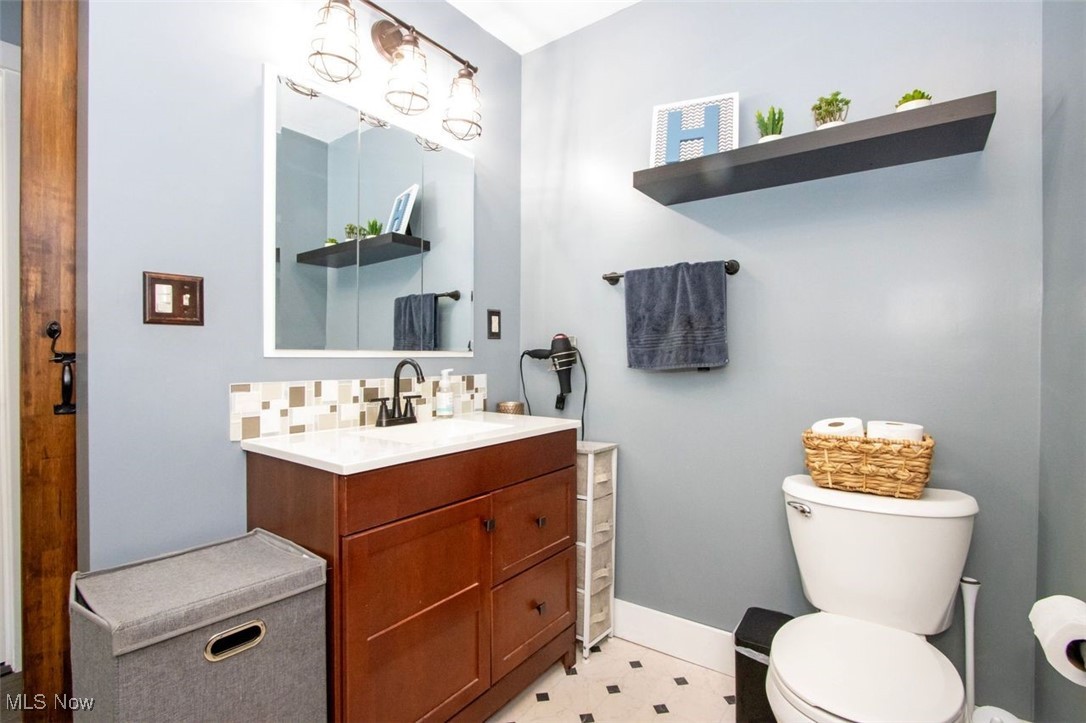 4184 Johnson Road Barberton, OH 44203 - Photo 15 of 25 Bathroom with vanity and decorative backsplash