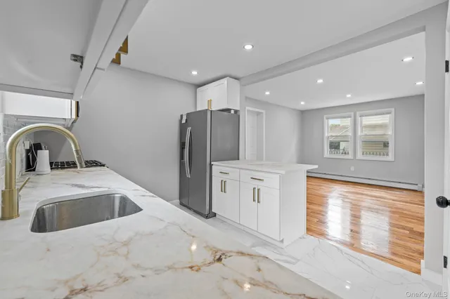 a kitchen with stainless steel appliances granite countertop a refrigerator and a sink