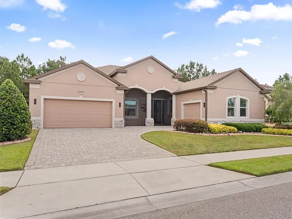 a front view of a house with a yard and garage