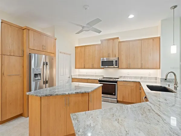a kitchen with stainless steel appliances granite countertop a sink counter space cabinets and stainless steel appliances
