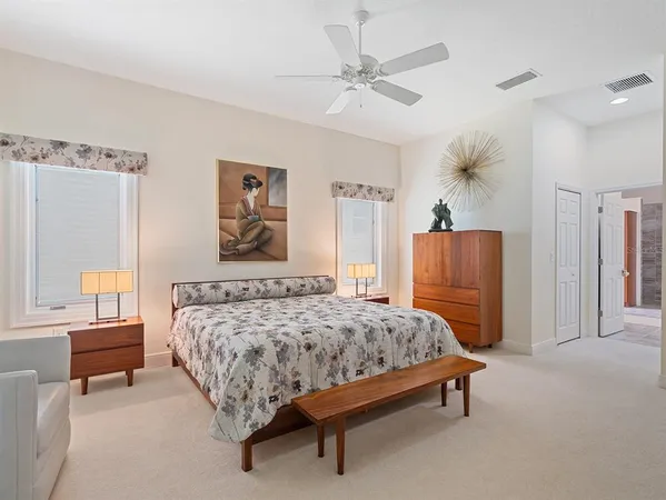 a bedroom with a bed and dresser with mirror