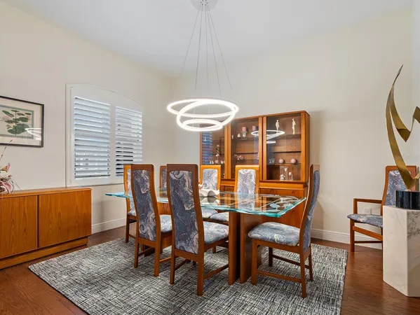 a dining room with furniture and wooden floor
