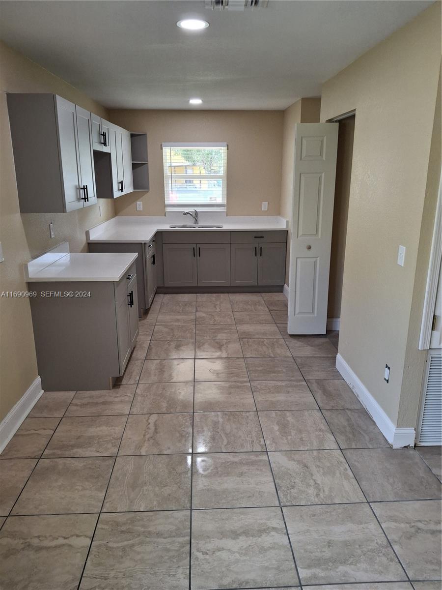509 North 22nd Street Fort Pierce, FL 34950 - Photo 10 of 18 a large kitchen with cabinets and glass door