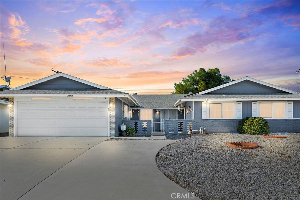 28811 Murrieta Road Sun City, CA 92586 - Photo 1 of 1 a front view of a house with a yard and garage