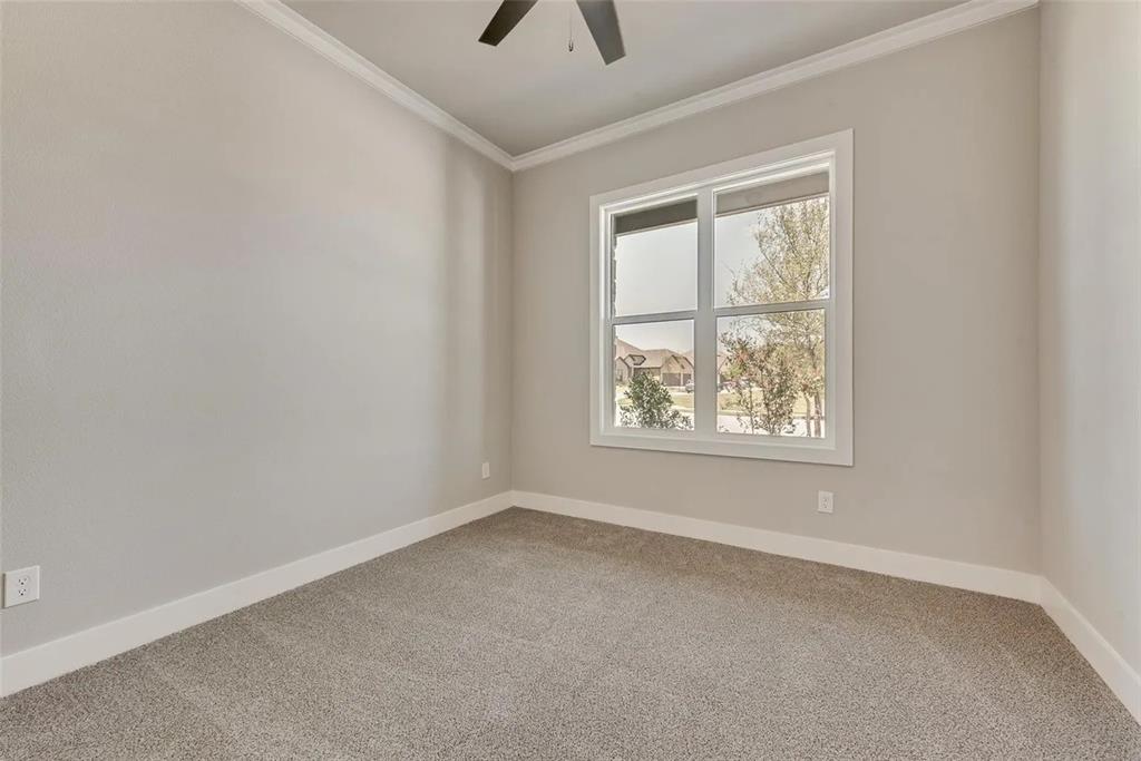 1327 Selby Road Van Alstyne, TX 75495 - Photo 13 of 32 Unfurnished room featuring light carpet, ornamental molding, and a ceiling fan