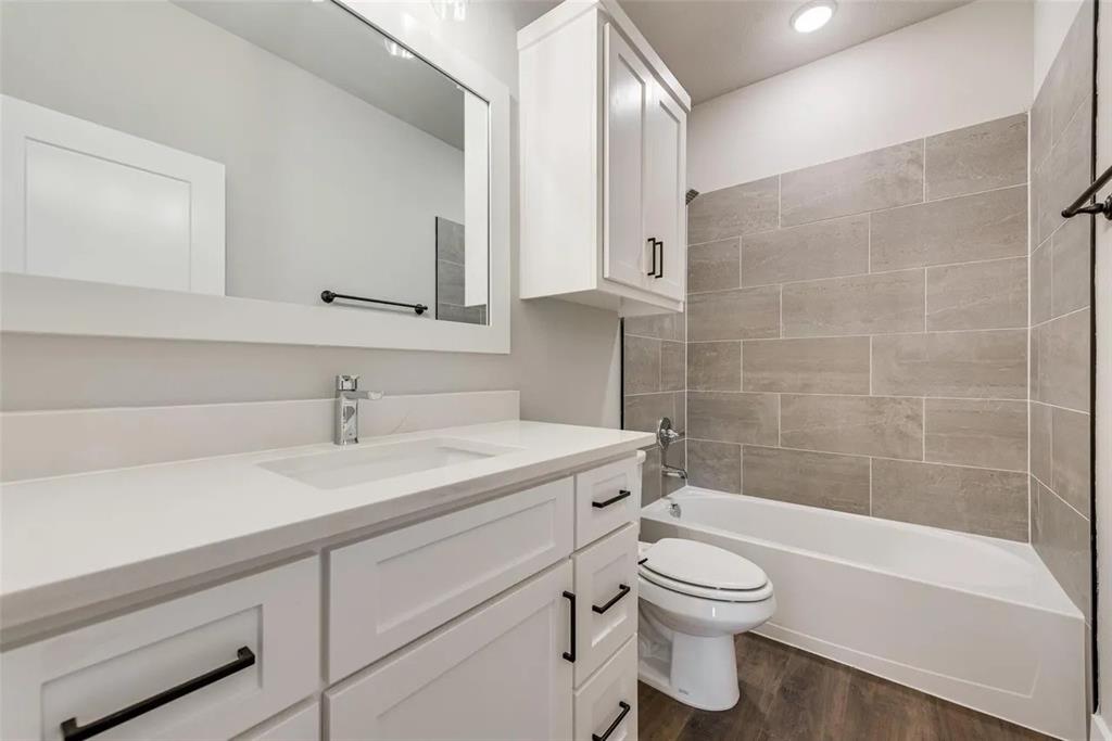 1327 Selby Road Van Alstyne, TX 75495 - Photo 15 of 32 Full bath featuring vanity, shower / bathtub combination, and dark wood-style flooring