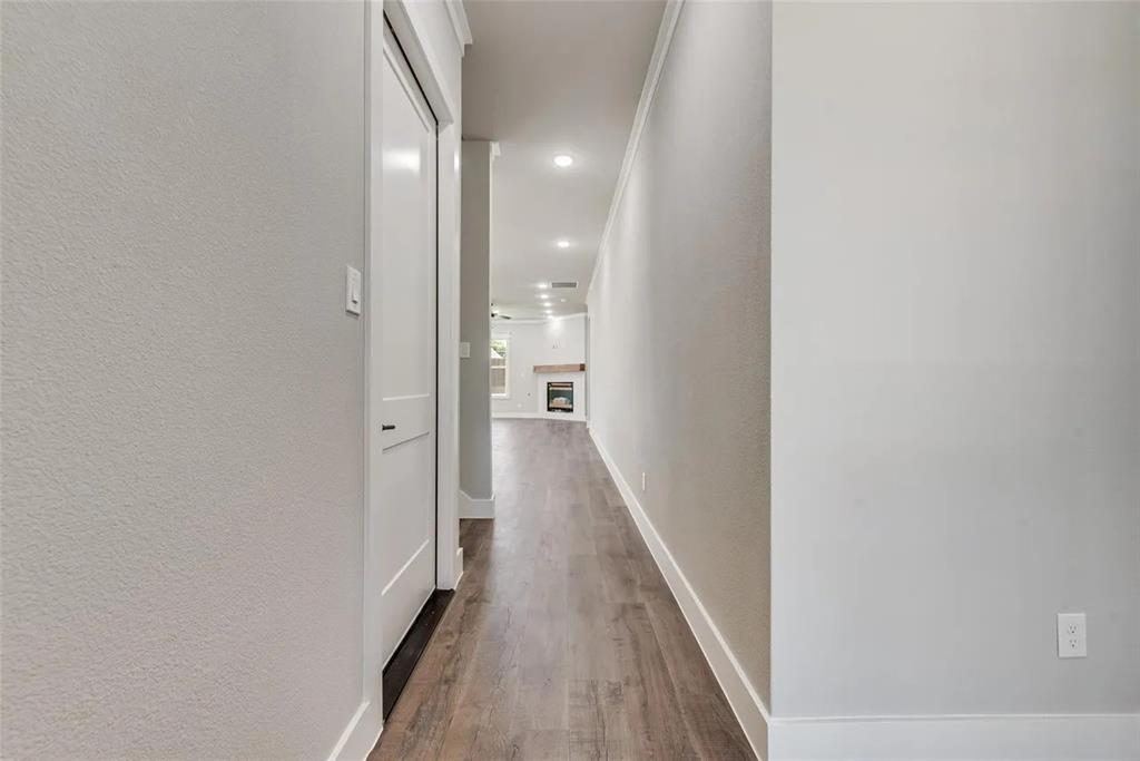 1327 Selby Road Van Alstyne, TX 75495 - Photo 28 of 32 Hallway with a textured wall, dark wood-style flooring, and recessed lighting