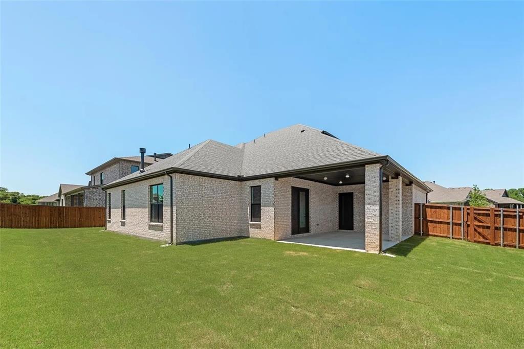 1327 Selby Road Van Alstyne, TX 75495 - Photo 30 of 32 Back of house with a fenced backyard, a patio, brick siding, and a shingled roof