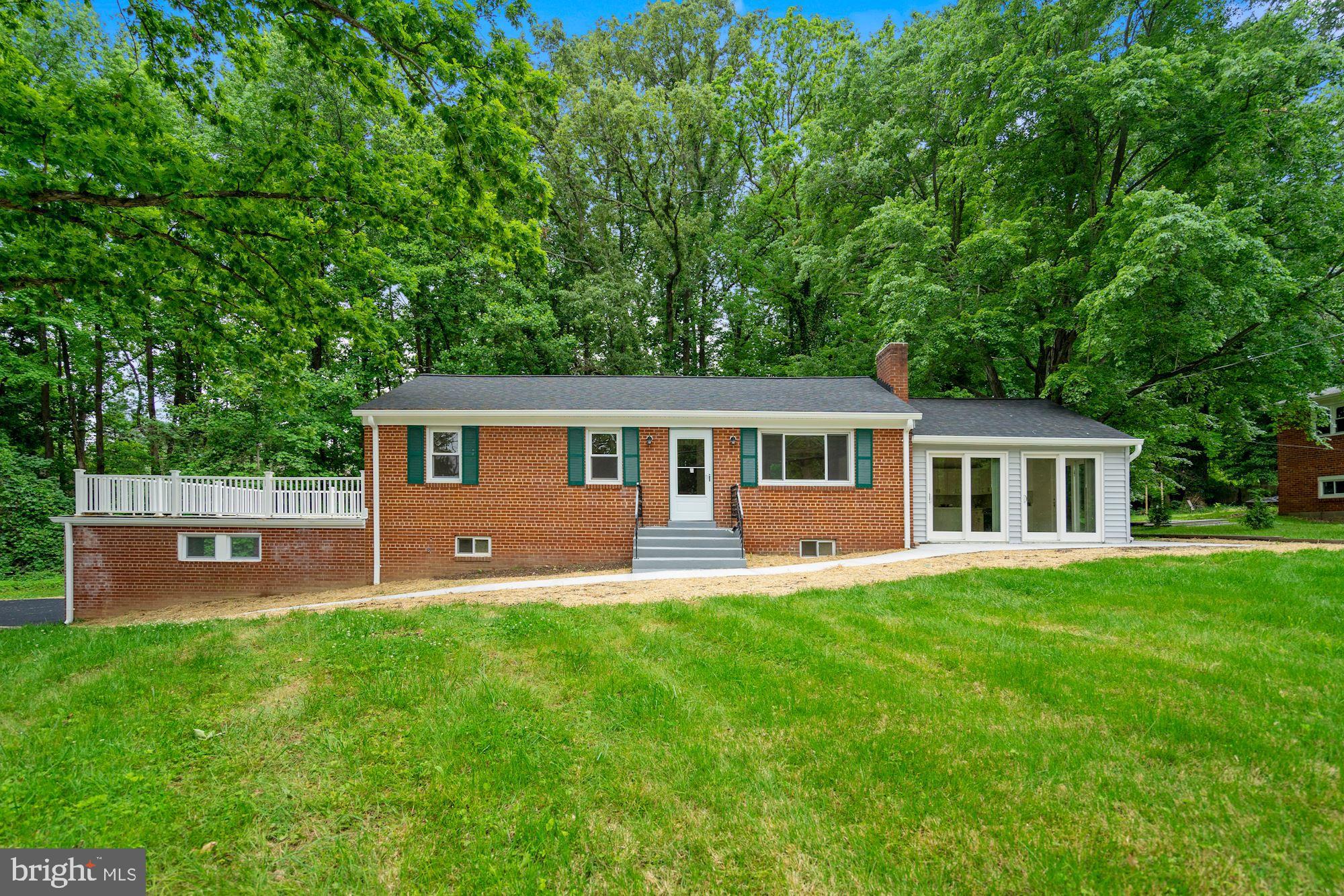 9101 Old Keene Mill Road Springfield, VA 22152 - Photo 1 of 28 a front view of a house with a yard and green space