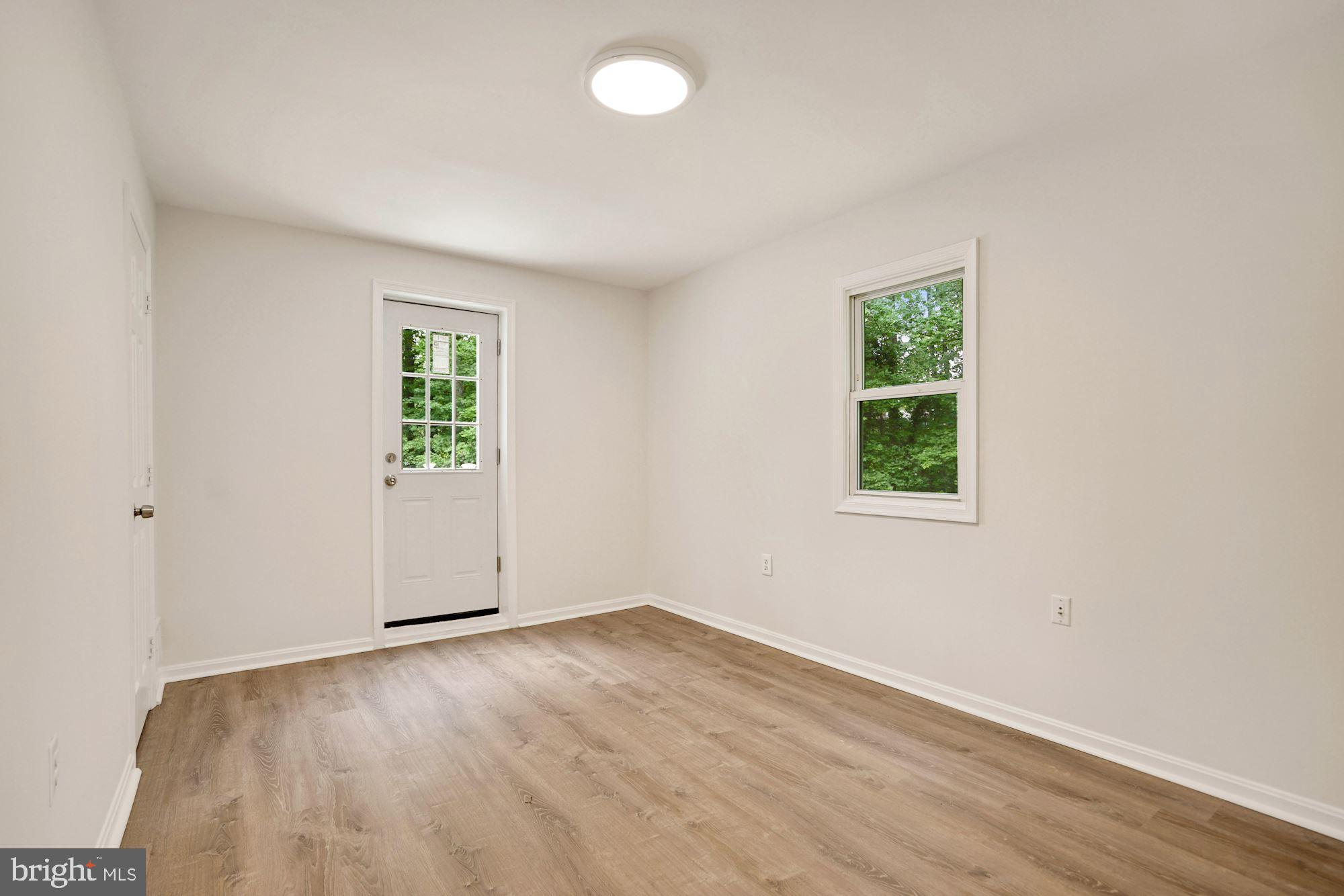 9101 Old Keene Mill Road Springfield, VA 22152 - Photo 12 of 28 an empty room with wooden floor and windows