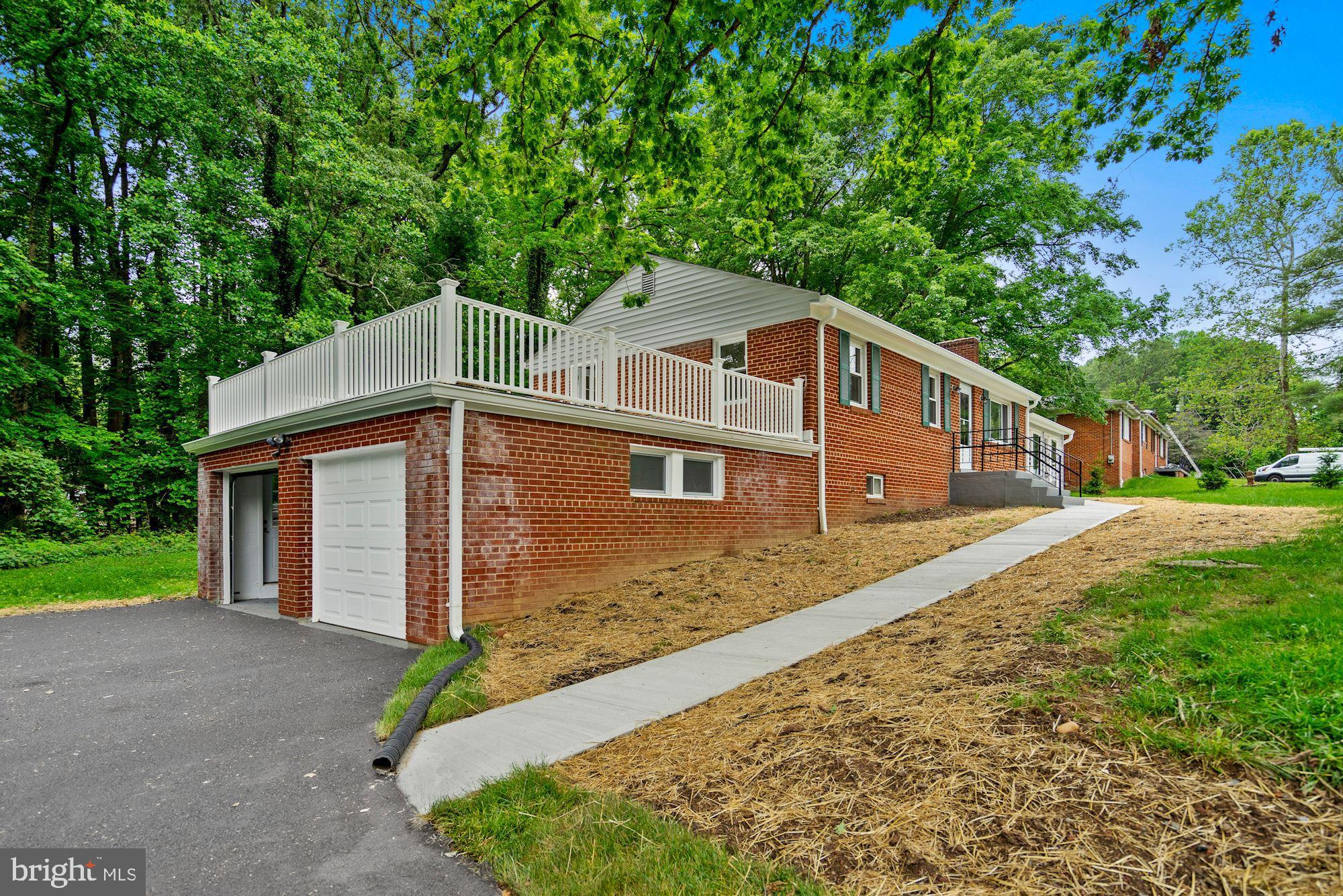 9101 Old Keene Mill Road Springfield, VA 22152 - Photo 3 of 28 a front view of a house with a yard