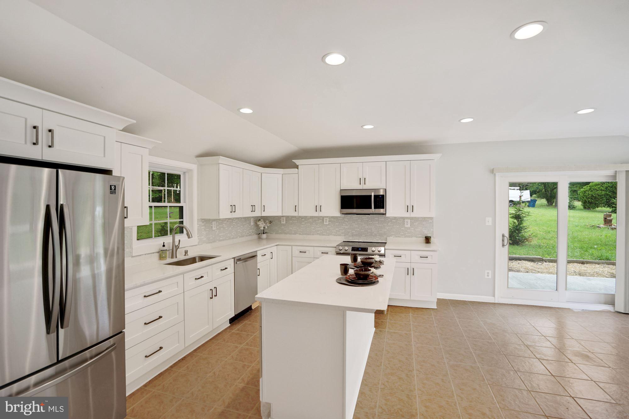 9101 Old Keene Mill Road Springfield, VA 22152 - Photo 4 of 28 a kitchen with stainless steel appliances a stove sink and cabinets