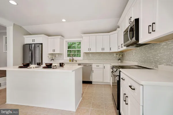 a kitchen with cabinets and stainless steel appliances