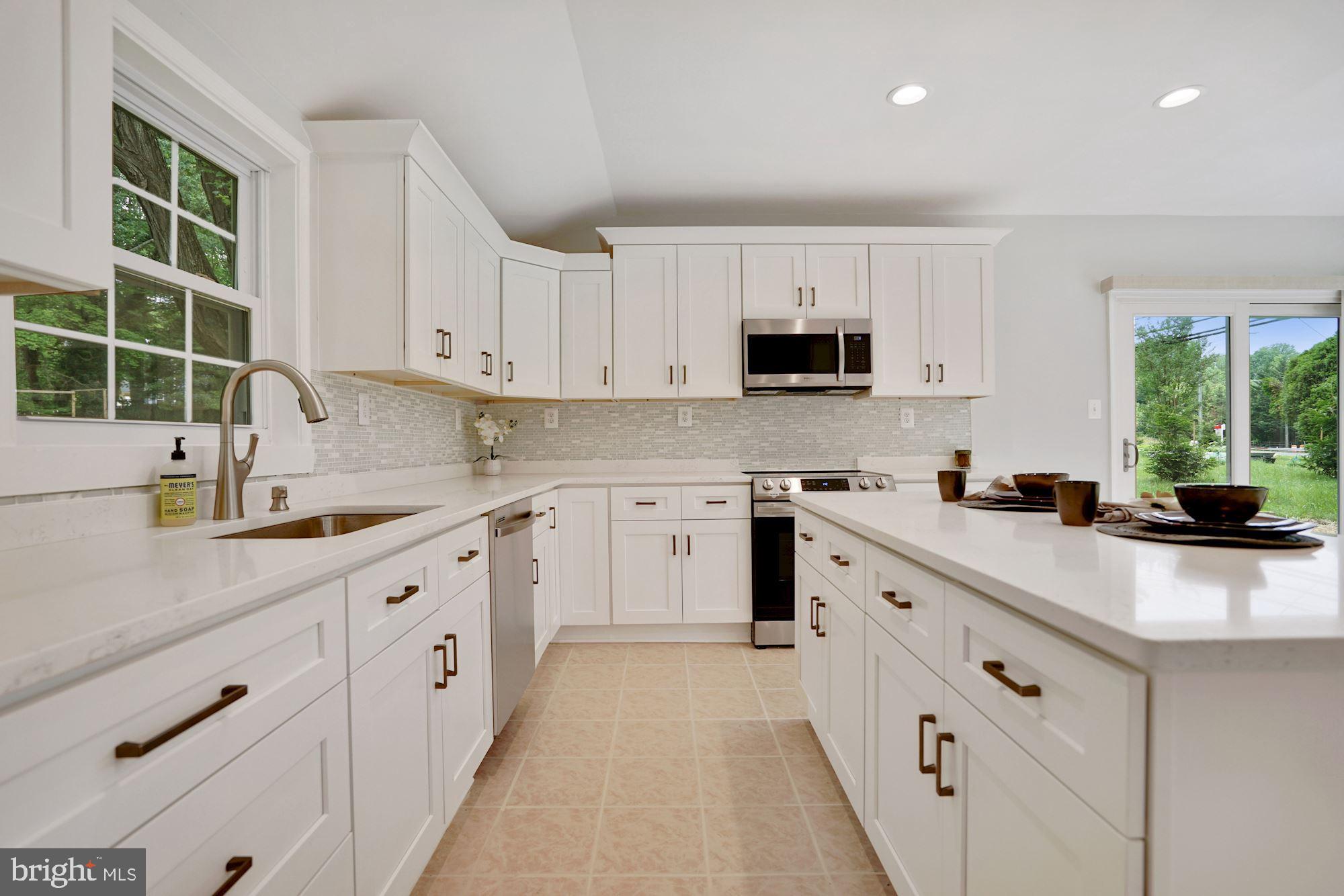 9101 Old Keene Mill Road Springfield, VA 22152 - Photo 6 of 28 a kitchen with cabinets appliances a sink and a window