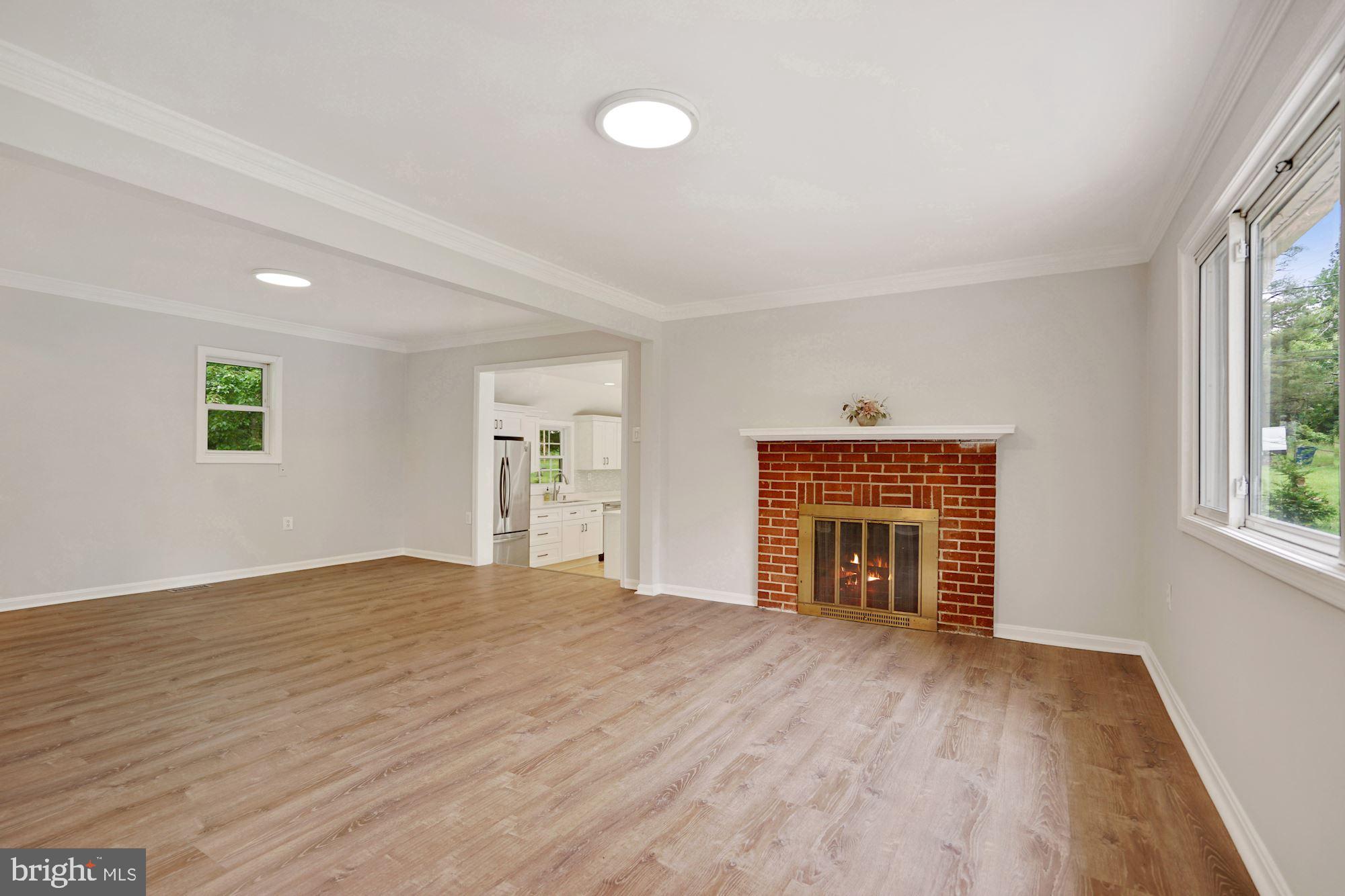 9101 Old Keene Mill Road Springfield, VA 22152 - Photo 7 of 28 an empty room with windows and fireplace