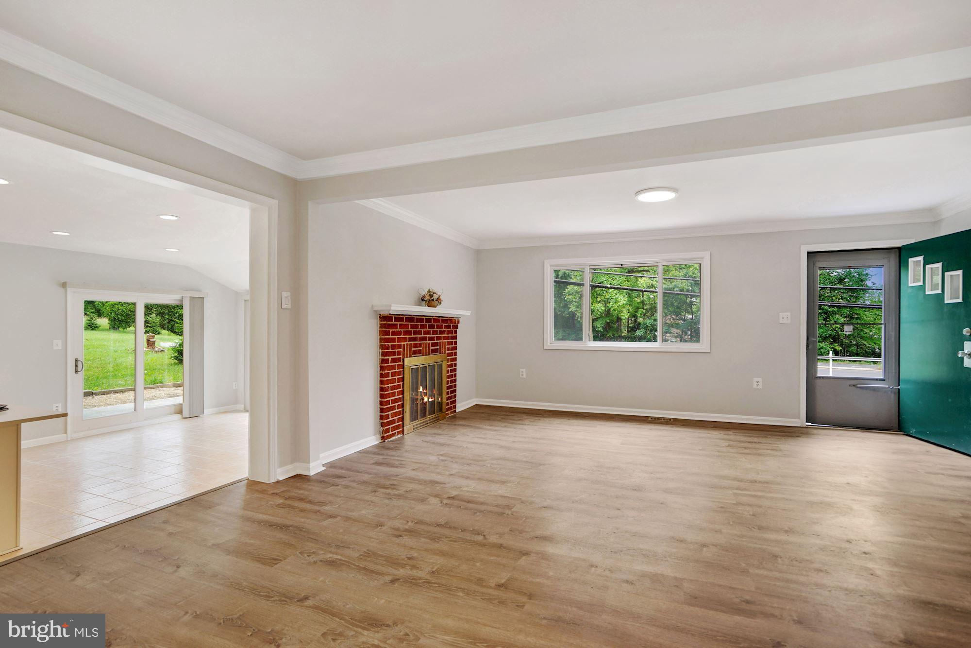 9101 Old Keene Mill Road Springfield, VA 22152 - Photo 8 of 28 an empty room with windows and a kitchen view