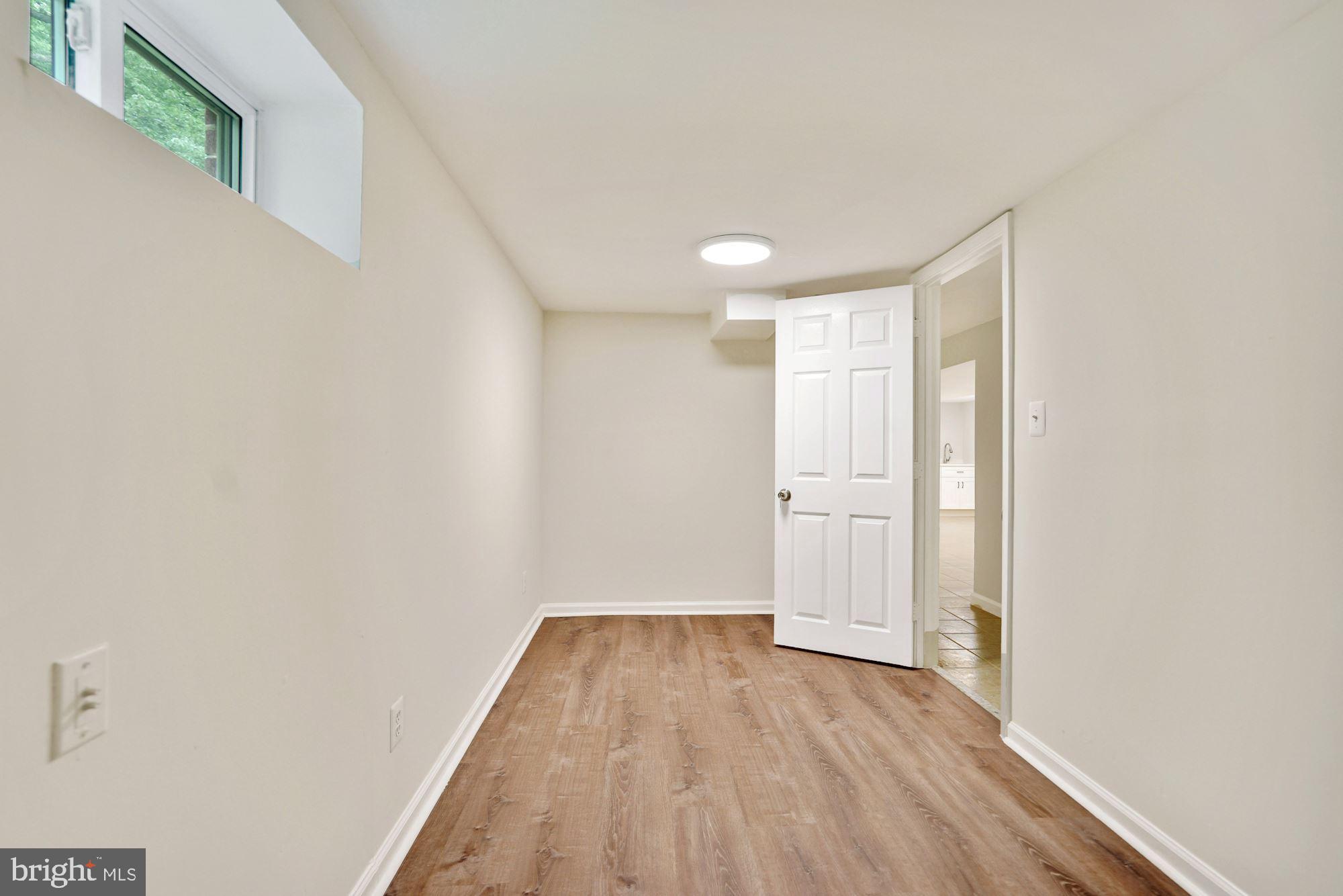 9101 Old Keene Mill Road Springfield, VA 22152 - Photo 9 of 28 a view of a room with wooden floor and white doors