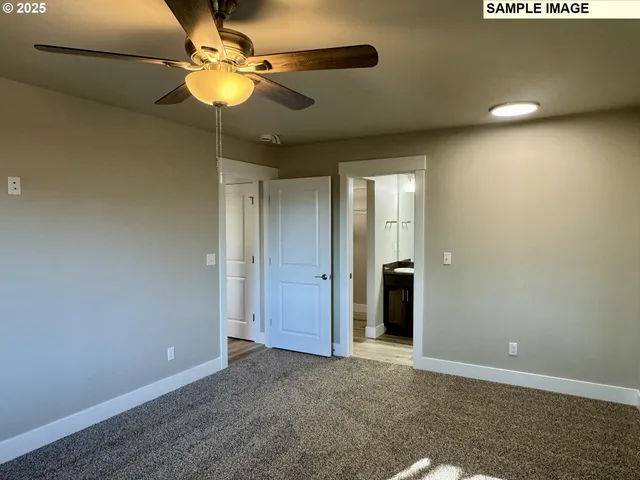 a view of an empty room with a ceiling fan