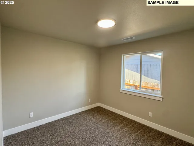 an empty room with closet area