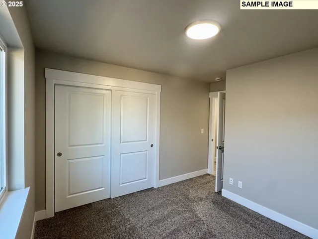 a bathroom with a granite countertop sink a toilet a mirror and bathtub