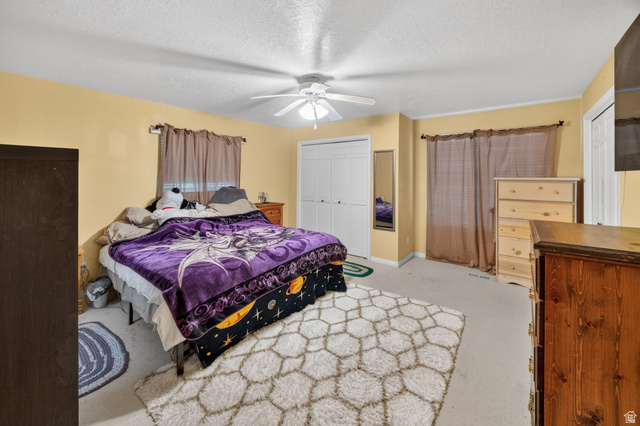 1218 East 100 South Logan, UT 84321 - Photo 14 of 23 Carpeted bedroom featuring light yellow walls and a white ceiling fan