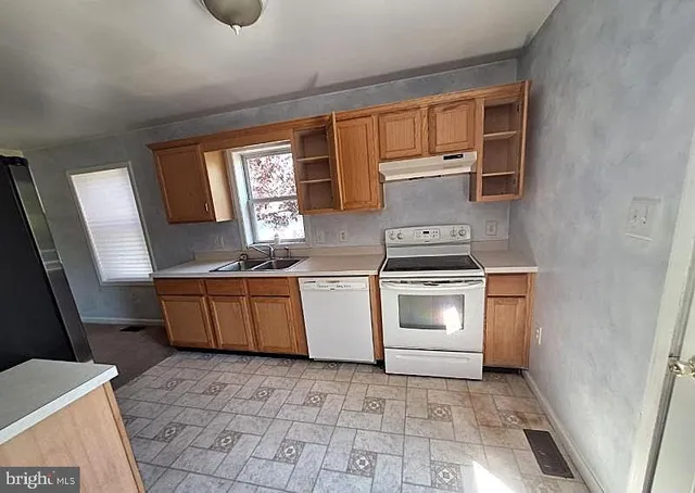 a kitchen with a stove a sink and a microwave