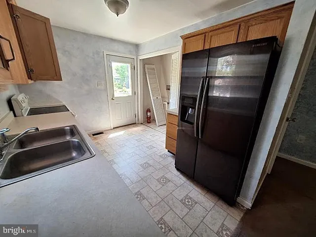 a kitchen with a refrigerator and a stove
