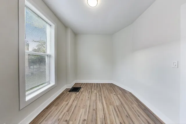 a view of a room with wooden floor and window