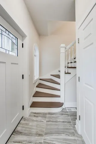 a view of a kitchen with wooden floor and white doors