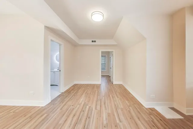 a view of a room with wooden floor and a sink