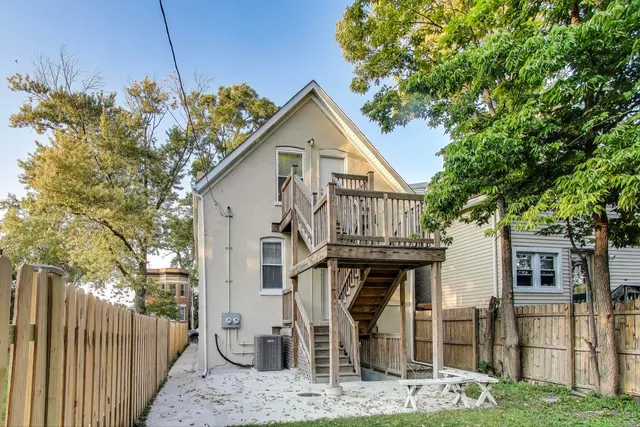 a view of a backyard with a tree