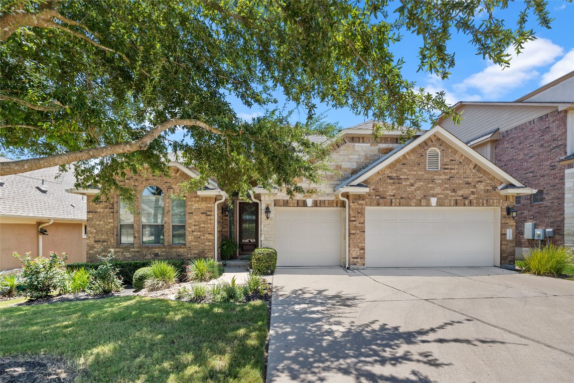 a front view of house with a garden